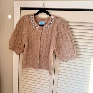 CeCe Beige Cable Knit Cardigan with Pearl and Rhinestone Embellishments.